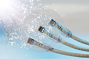 Closeup of RJ45 UTP LAN on the background of optical fibers with blurred lights