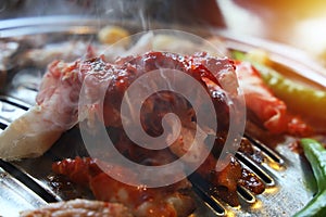 Closeup Roast pork on a charcoal stove is about to be cooked.