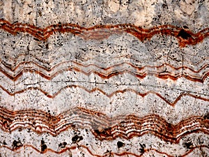 Closeup of a rock polished to show texture background trail of time grand canyon forming a mountain pattern