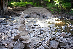 Stone cairn along peaceful forest stream