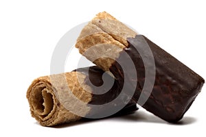 Closeup rolled wafers covered chocolate white background