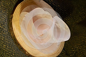 Closeup of rose quartz heart-shaped mugs and plate on a wooden board