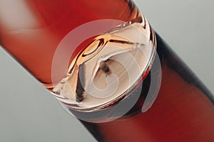 Closeup of a rose wine bottle punt with reflection