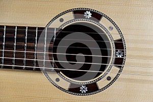 Closeup of rosette sound hole of an acoustic guitar