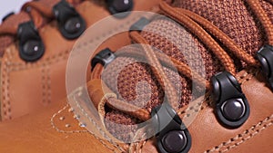 Closeup of rotating pair of fashionable weatherproof leather rufous boots
