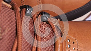 Closeup of rotating pair of fashionable weatherproof leather rufous boots