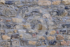 Closeup rough basalt texture of old medieval stone wall, brown natural backdrop, stone, bridge road, pavement, pattern, texture,