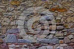 Closeup rough sandy texture of old medieval stone wall, brown natural backdrop, stone, brickwork, pattern, texture, fragment of