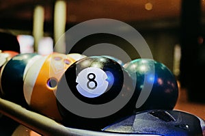 Closeup of the round black billiard ball with the number 8