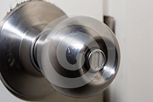 Closeup of a round door handle knob with push lock