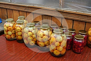 Closeup of a row of homemade fruit compotes for winter photo