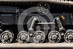 A closeup of rubber tractor tracks