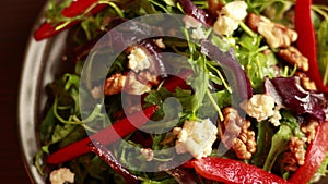 CloseUp of Rucola, Onion, Canned Red Peppers, and Walnuts Winter Salad