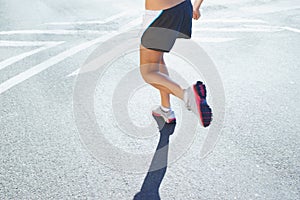 Closeup, running and legs with woman, fitness and exercise with progress, endurance and challenge. Person, athlete and