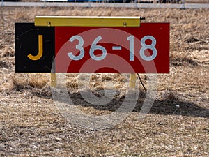 Closeup of runway hold position sign at taxiway J