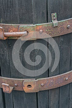 Closeup of rusted brass details with peeling green paint on a vintage rustic wine casket