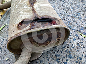 Rusted broken muffler of car silencer photo
