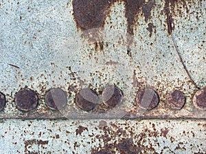 Closeup rusted grunge metal surface with white paint