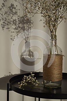 Closeup of a rustic vase filled with dried plants on the table