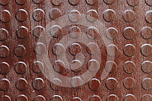 Closeup of rusty metal with knobs