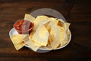 closeup salsa nachos on a white platter