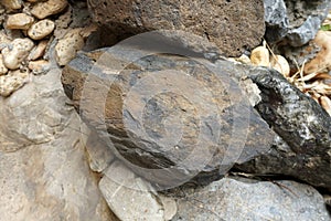 Closeup of sample of natural basalt rock. Basalt is an extrusive igneous rock. photo