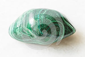 Polished Malachite rock on white marble