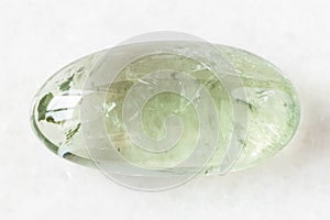 Polished Prasiolite green quartz rock on white photo