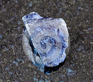 unpolished Cordierite (Iolite) crystal on black photo
