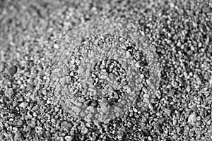 Closeup of sand on the beach. Crystals of sea sand as background. Macro black and white