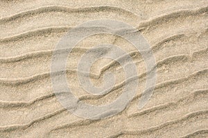 closeup of sand pattern of a beach in the summer