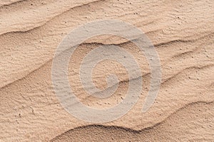Closeup of sand pattern of a beach in the summer
