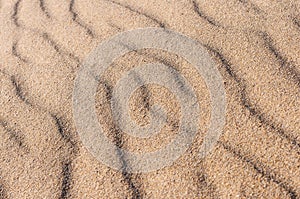Closeup Of sand pattern of a beach in the summer