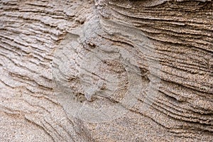 Closeup of sand with waves pattern. Beautiful natural background. Sand sea beach.
