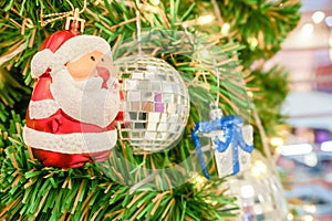 Closeup Santa Claus, crystal ball with a gift box and Christmas lights decorated on pine tree on Christmas day