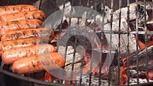 Closeup of sausage on the grill. Sausages are grilled BBQ. Grilled sausage on the flaming grill