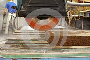 Closeup of a saw cutting stone at a factory