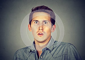 Closeup scared frightened young man