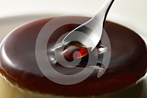 Closeup of scooping cream caramel with spoon 2