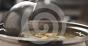 Closeup scooping fish soup with salmon