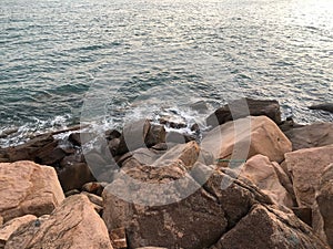 Closeup of sea waves breaking rocky beach