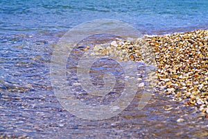 Closeup on sea waves on pebble beach