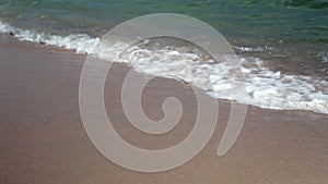 Closeup Of Sea Waves Washing Ashore A Sandy Beach.