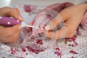 Closeup on seamstress unthread