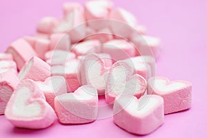 Closeup with selective focus pink marshmallows with heart shape