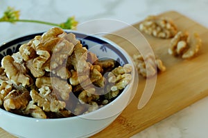 Closeup and selective focus of shelled walnuts pile in a bowl