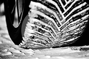 Closeup selective focus on snow packed in an all-weather tire tread.