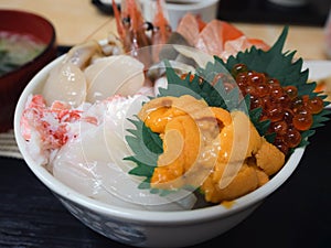 Seafood topped on rice bowl in Japanee style, uni sea urchin, salmon roe eggs, hotate scallops, crab meat and shrimps