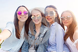 A closeup selfie of groups of female students in nature