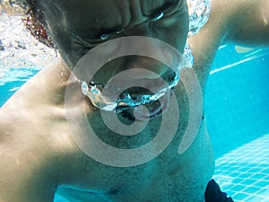 Closeup of senior black man underwater at swimming pool